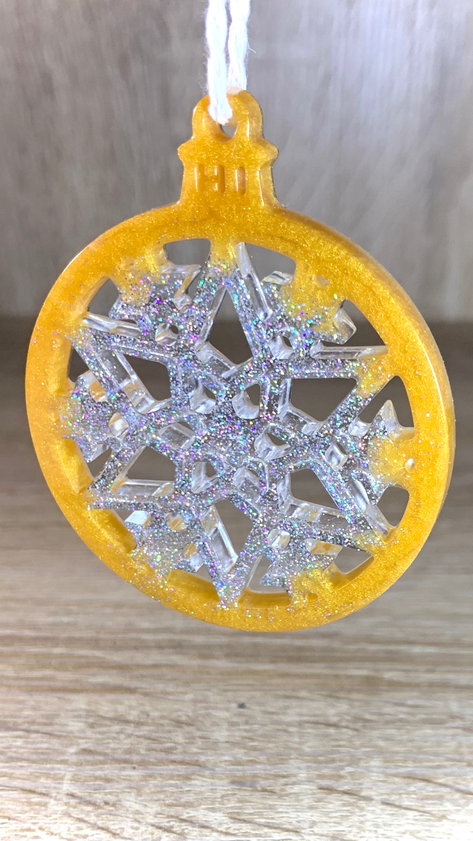 Gros plan sur les paillettes argentées dans la résine dorée